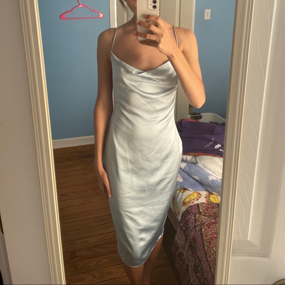 Mid length ice blue silk dress.